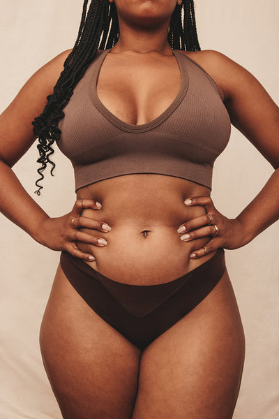 Female body wearing brown underwear