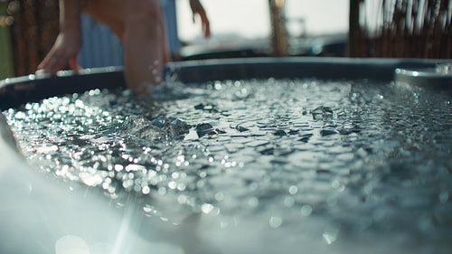 Woman in cold plunge ice bath outdoors for recovery and wellness training