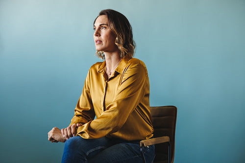 CEO and company owner sitting on a chair in a corporate business office