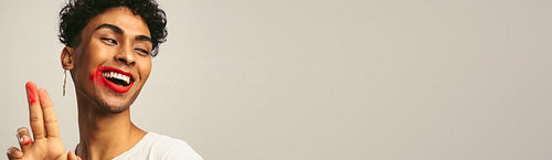 Genderqueer with smeared lipstick on his face