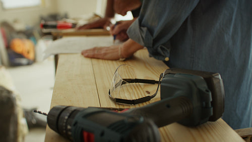 Tackling it together: A woman and man reviewing home renovation plans