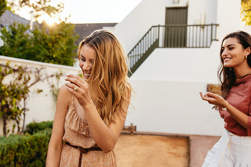 Carefree female friends laughing outdoors