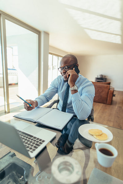 Businessman talking over mobile phone at work