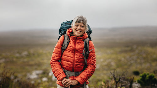 Female hiker standing on a hill