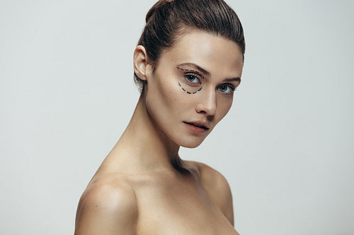 Woman face with dotted lines before plastic surgery