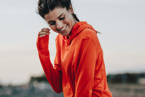 Smiling sportswoman in tracksuit