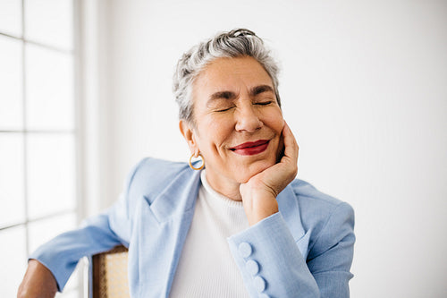 Success and happiness for this elegantly dressed senior business woman
