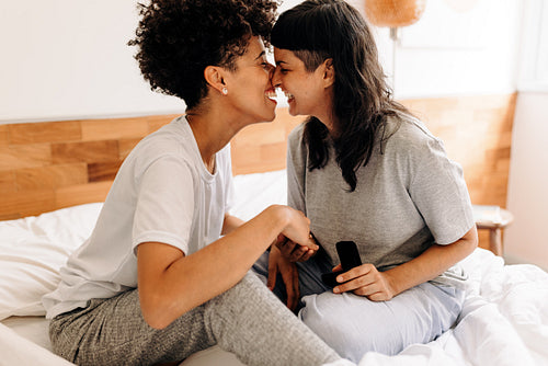 Queer couple celebrating their engagement at home