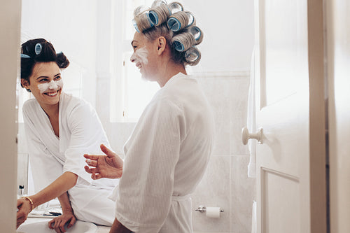 Two women having fun while grooming at home