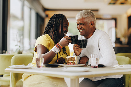 Mature couple enjoying themselves in a coffee shop