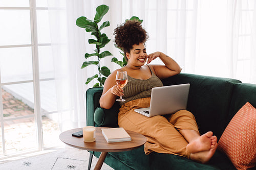 Woman with wine enjoying watching movie