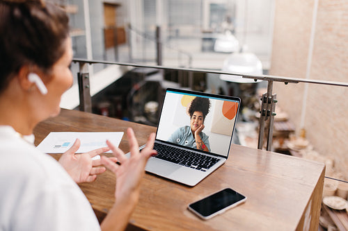 Small business owner having a video call in a warehouse