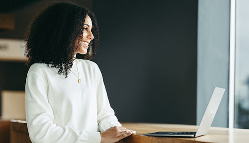 Happy young businesswoman working in a co-working space