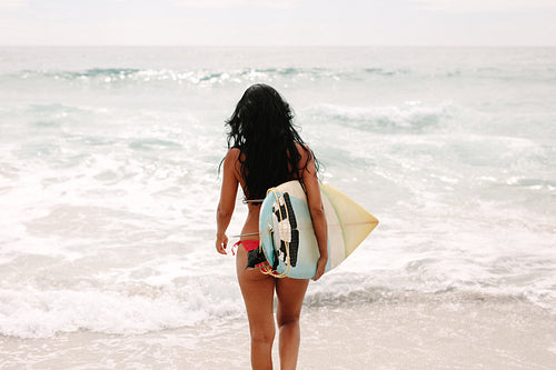 Surfer girl going in the water