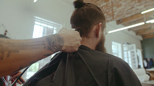 Man getting trendy haircut at salon