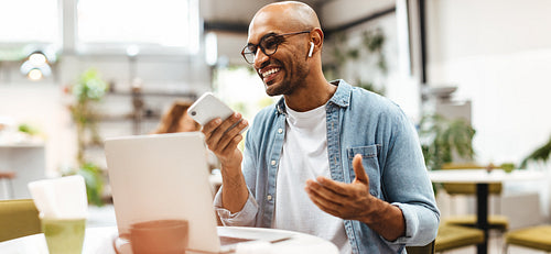 Remote entrepreneur making a phone call while working in restaurant
