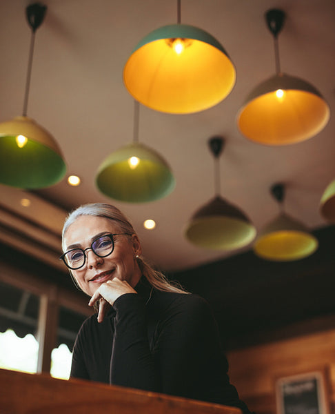 Mature woman reading a book in modern cafe