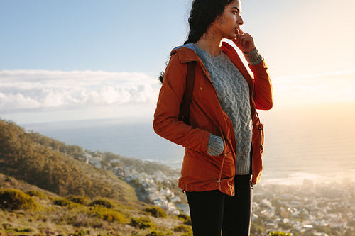 Woman admiring a view from cliff on a winter day