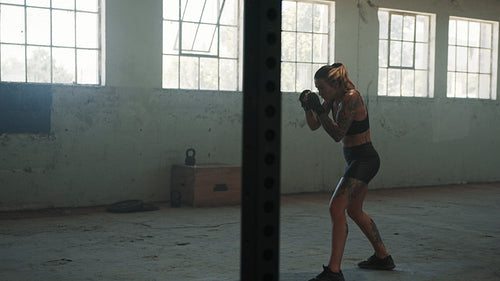 Woman practising shadow boxing in gym