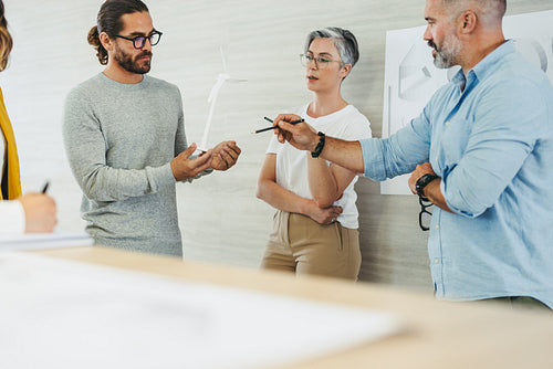 Group of creative designers working on a wind turbine project