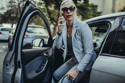 Female entrepreneur travelling to office in a luxurious car