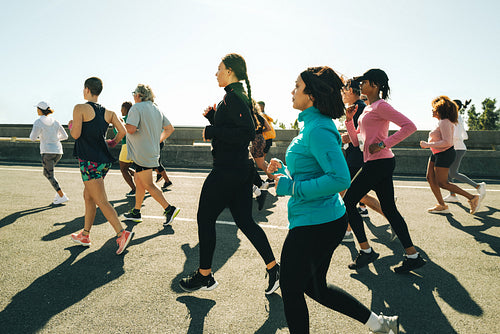 Group of people running together in a community outdoor event