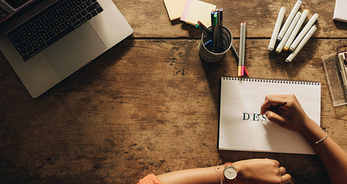 Young designer drawing on a note pad