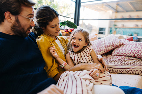 Family moment with parents and daughter at home