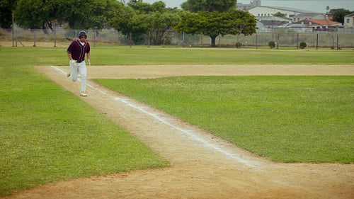 Baseball player slides safely into home plate