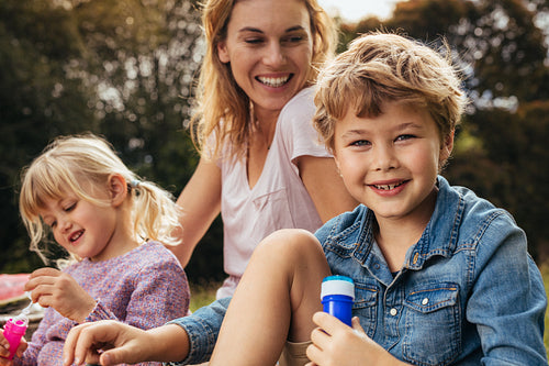 Family of three having picnic at park