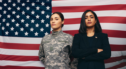 Soldier and politician standing against an American flag