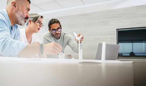 Team of creative designers working with 3D wind turbine models