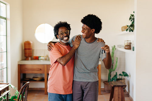 Cheerful father and son enjoy quality time together at home