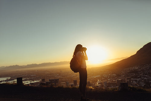 Female traveler taking pictures with camera