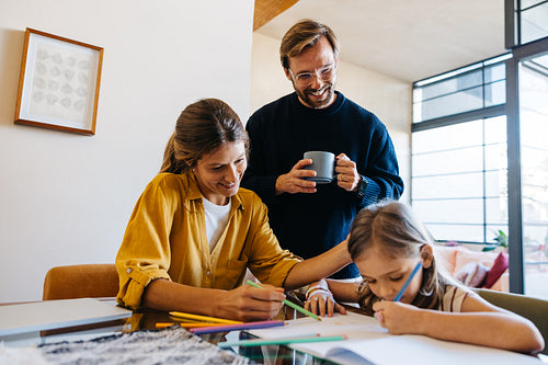 Family drawing session at home with parents and daughter