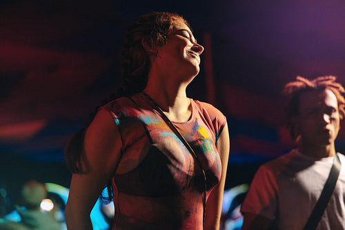 Young woman dancing the night away at a music festival party