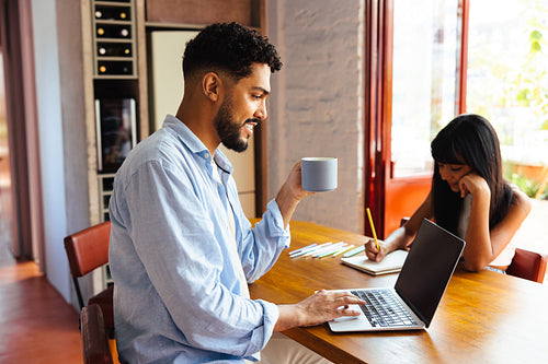 Father and daughter working together in a bright and comfortable home setting
