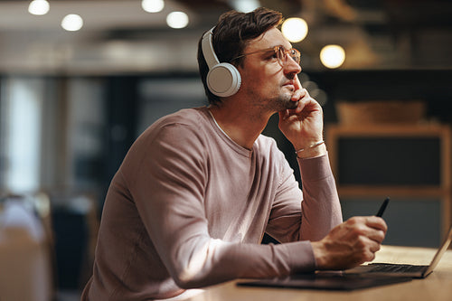 Web designer thinking about his project in a cafe