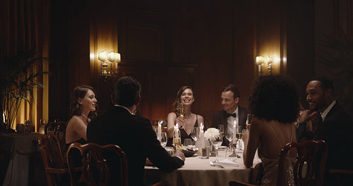 Socialites celebrating with wine at dinner party