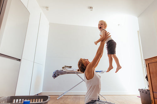 Mother and son playing in laundry room