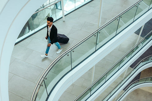 Businessman walking through an airport lounge