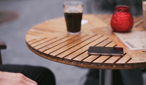 Mobile phone on street cafe table