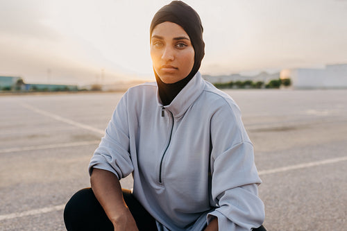 Sportswoman with a hijab looking at the camera outdoors