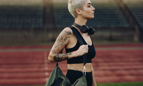 Woman athlete standing in a track and field stadium