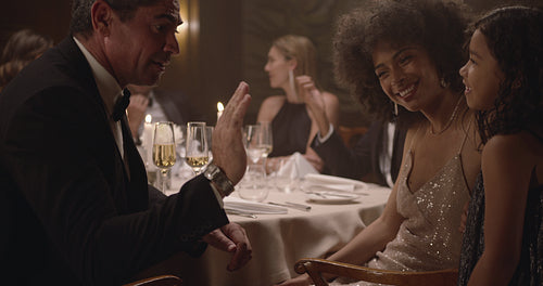 Man playing with a girl at dinner party