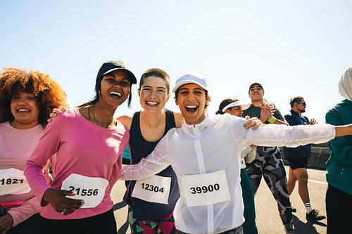 Diverse group of happy runners celebrating on race day