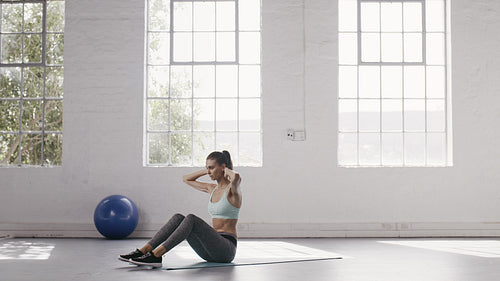 Woman doing abs workout at fitness studio