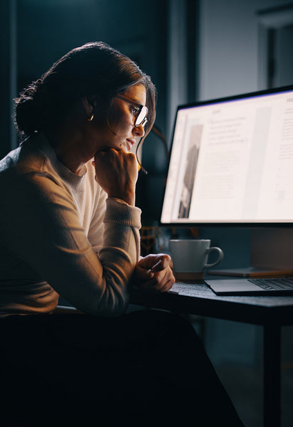 Working late in a home office: A young businesswoman planning a project
