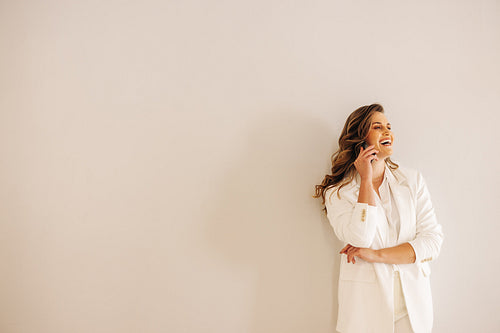 Happy businesswoman speaking on the phone in an office