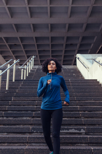 Woman running down the stairs of a building